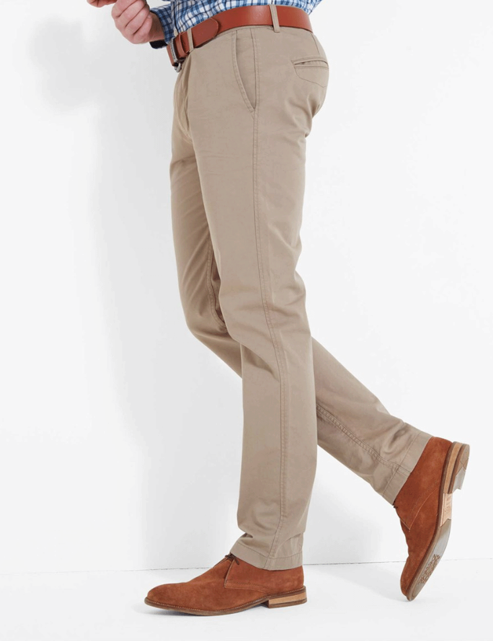 Man leaving against a wall wearing the Christopher Chino