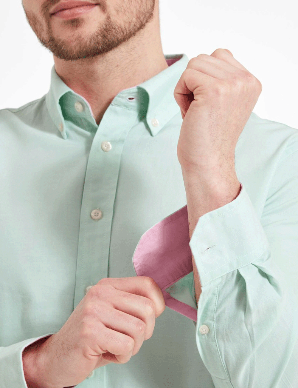 Man wearing the Titchwell Shirt holding the left cuffs= with his right hand