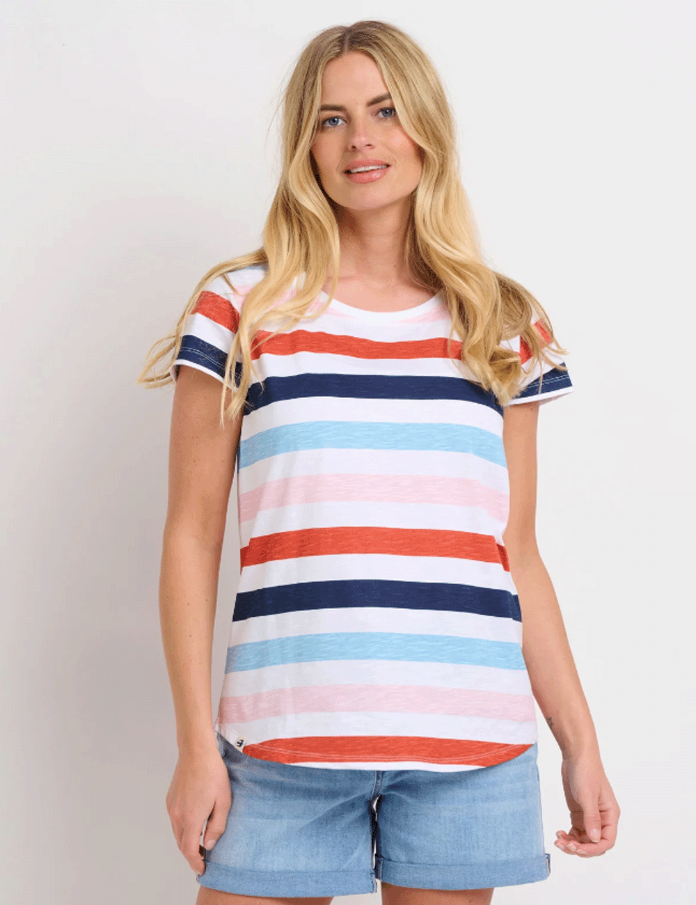 Woman wearing the Anna Stripe T-Shirt with denim shorts