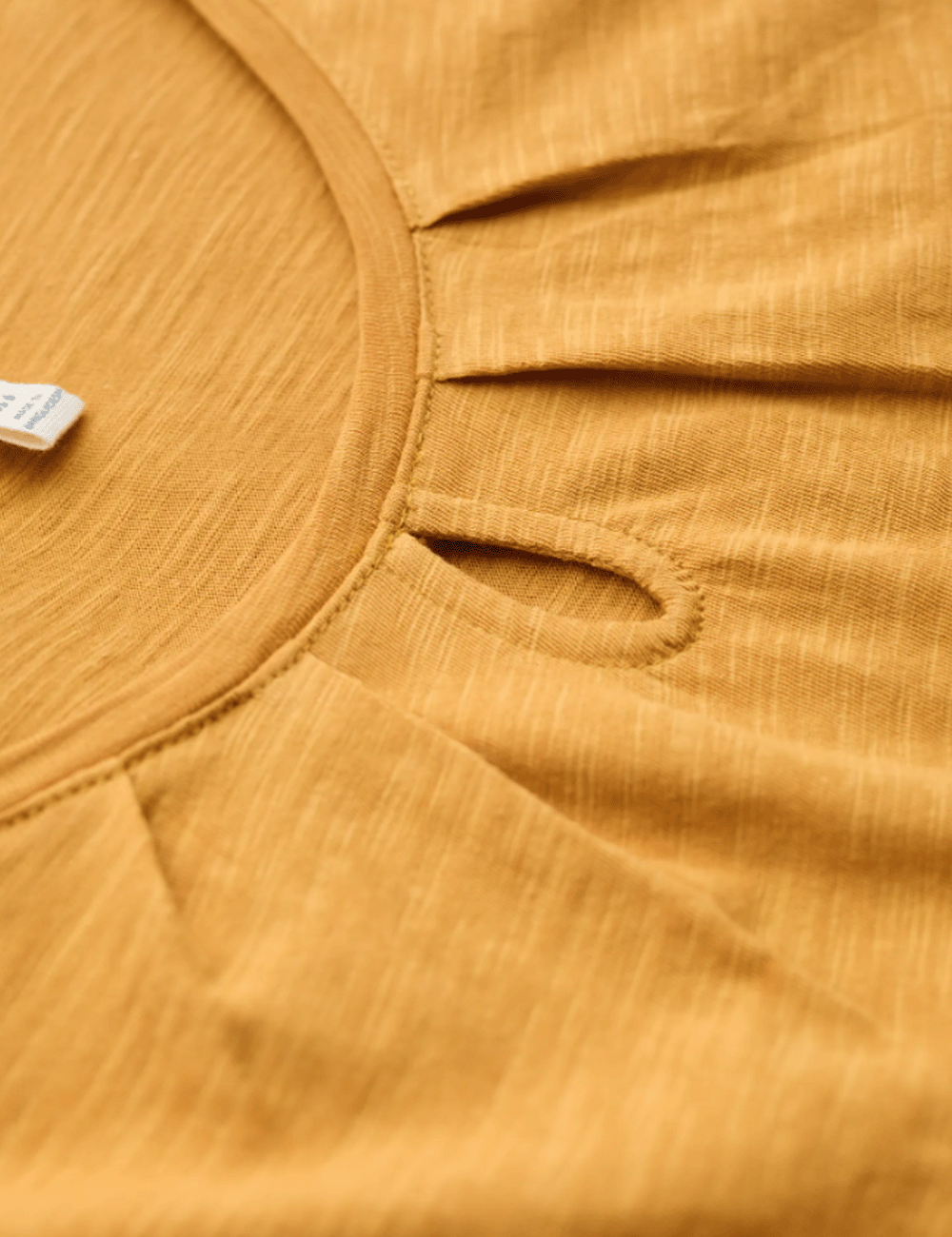 Close up of the keyhole detailing on the neckline of the Appletree Top