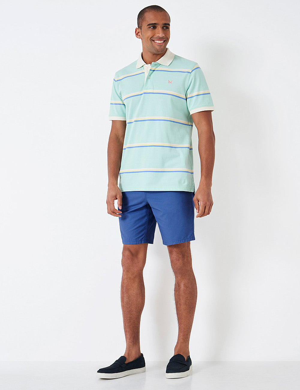 Man wearing the Bermuda Shorts with a striped polo shirt