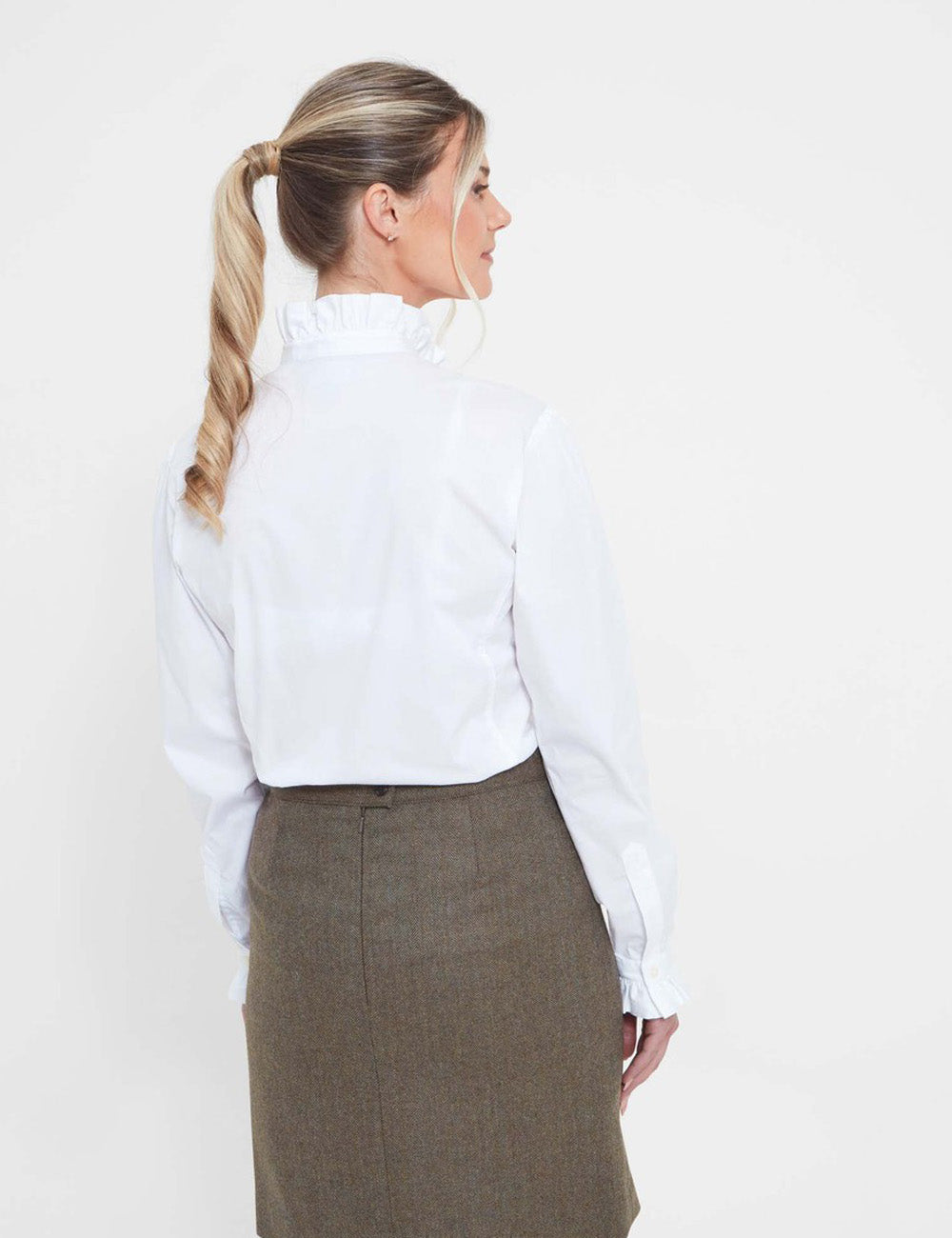 Woman facing away wearing the Fakenham Shirt with a tweed skirt