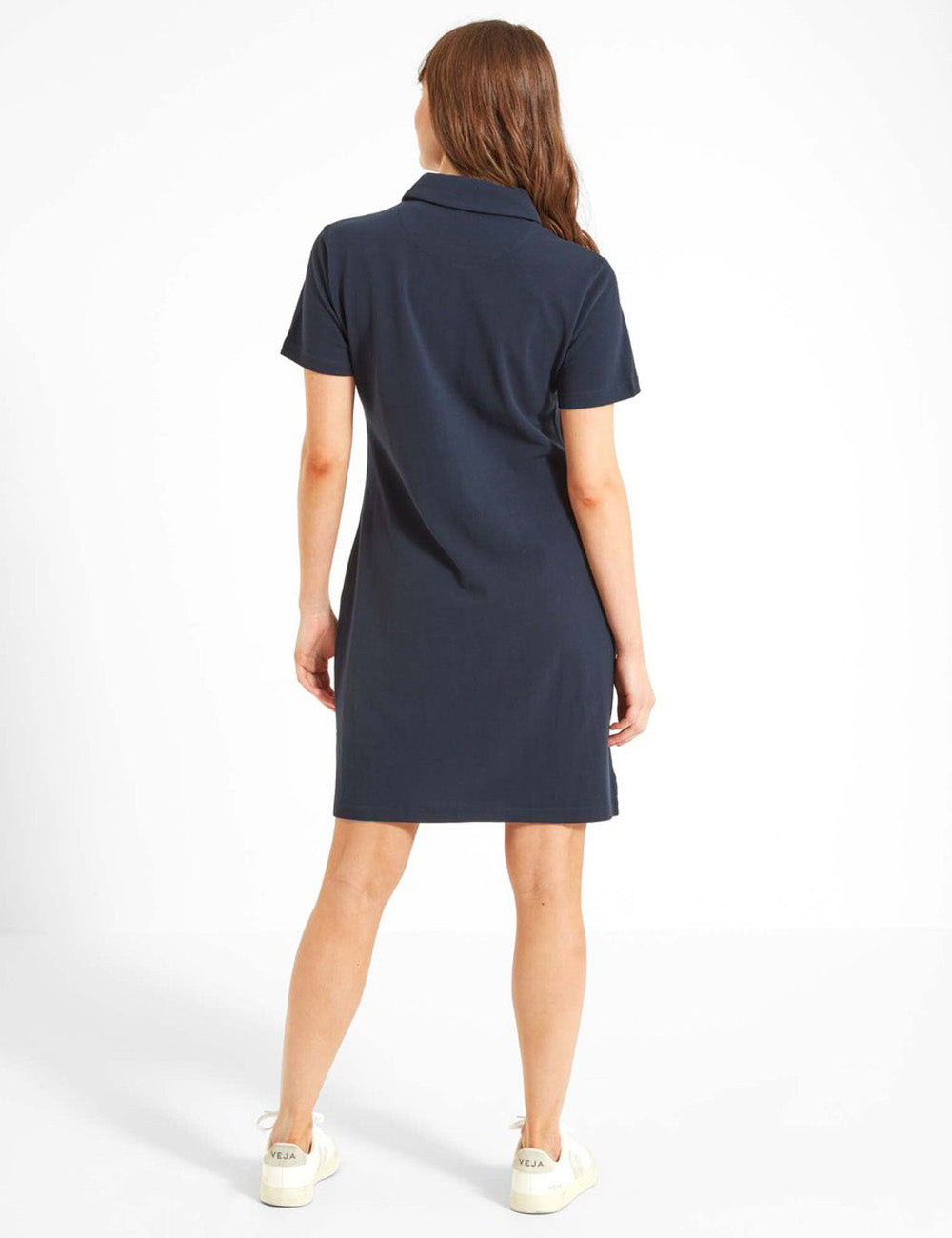 Woman facing away wearing the St. Ives Polo Dress with white trainers