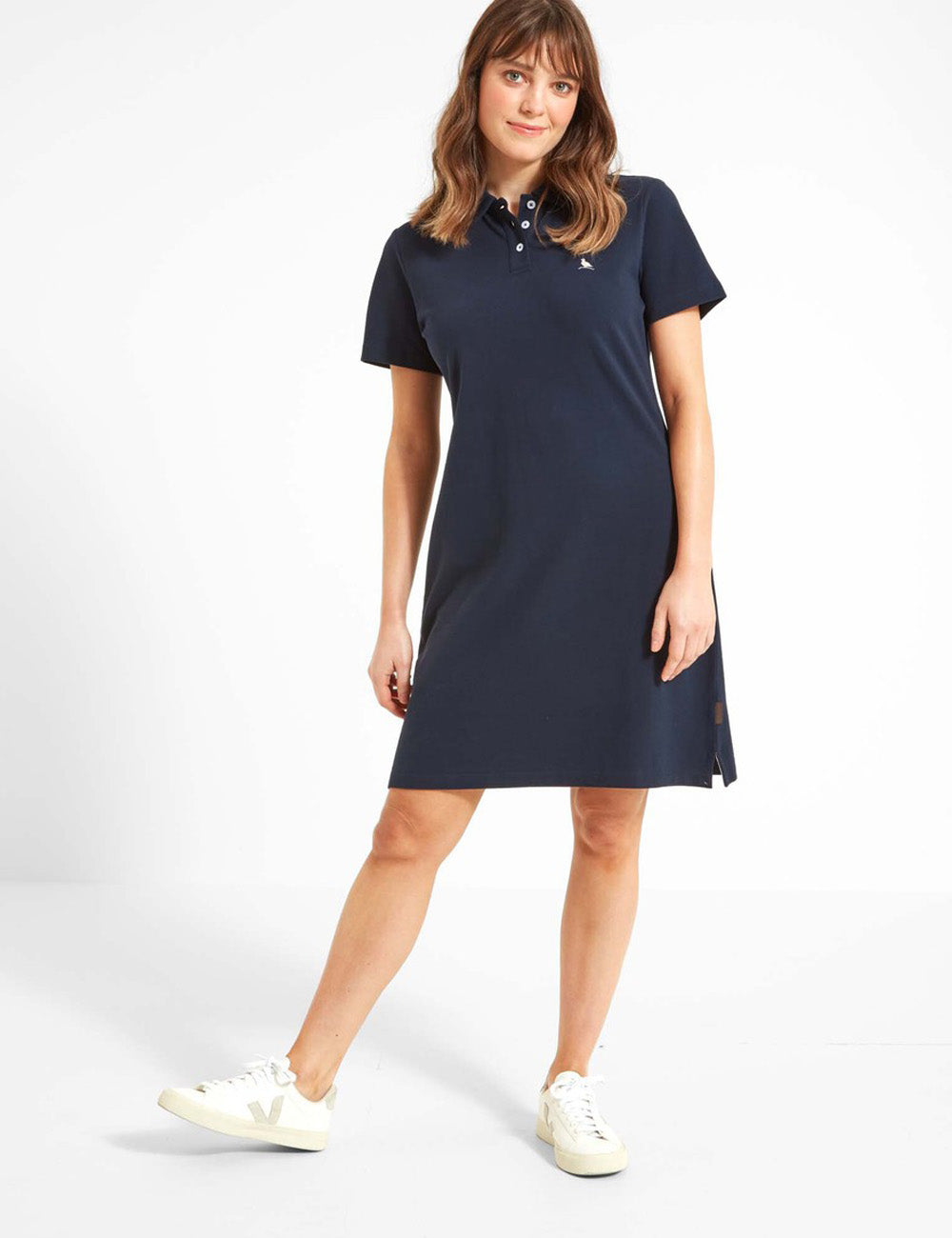 Woman wearing the St. Ives Polo dress with white trainers