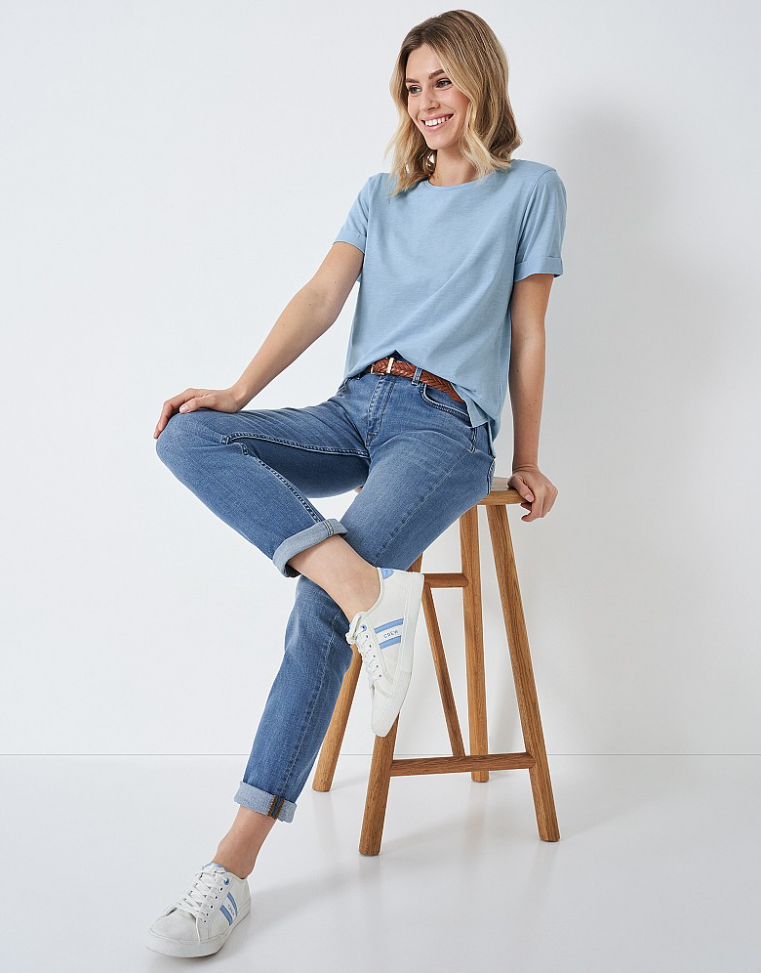 Woman sitting on stool wearing the Crew Clothing Straight Jeans
