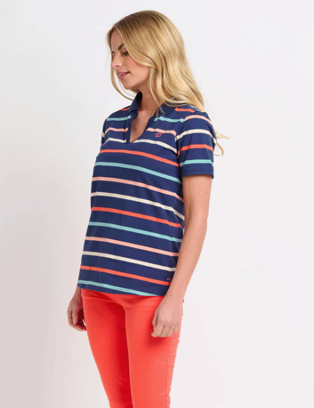 Woman wearing the Stripe Polo Shirt with red trousers