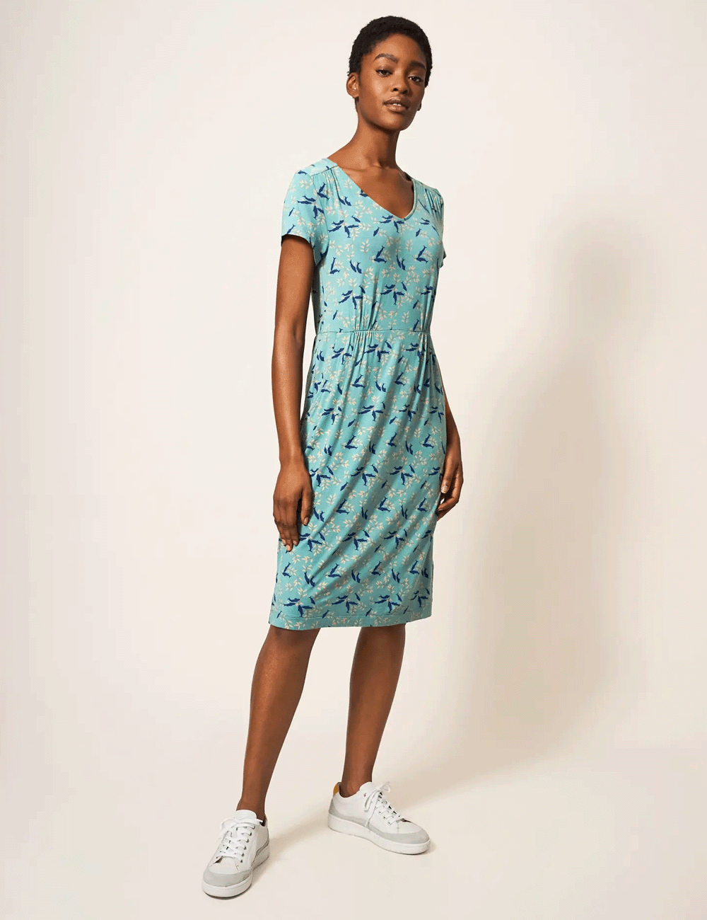 Woman wearing the Tallie Jersey Dress with trainers