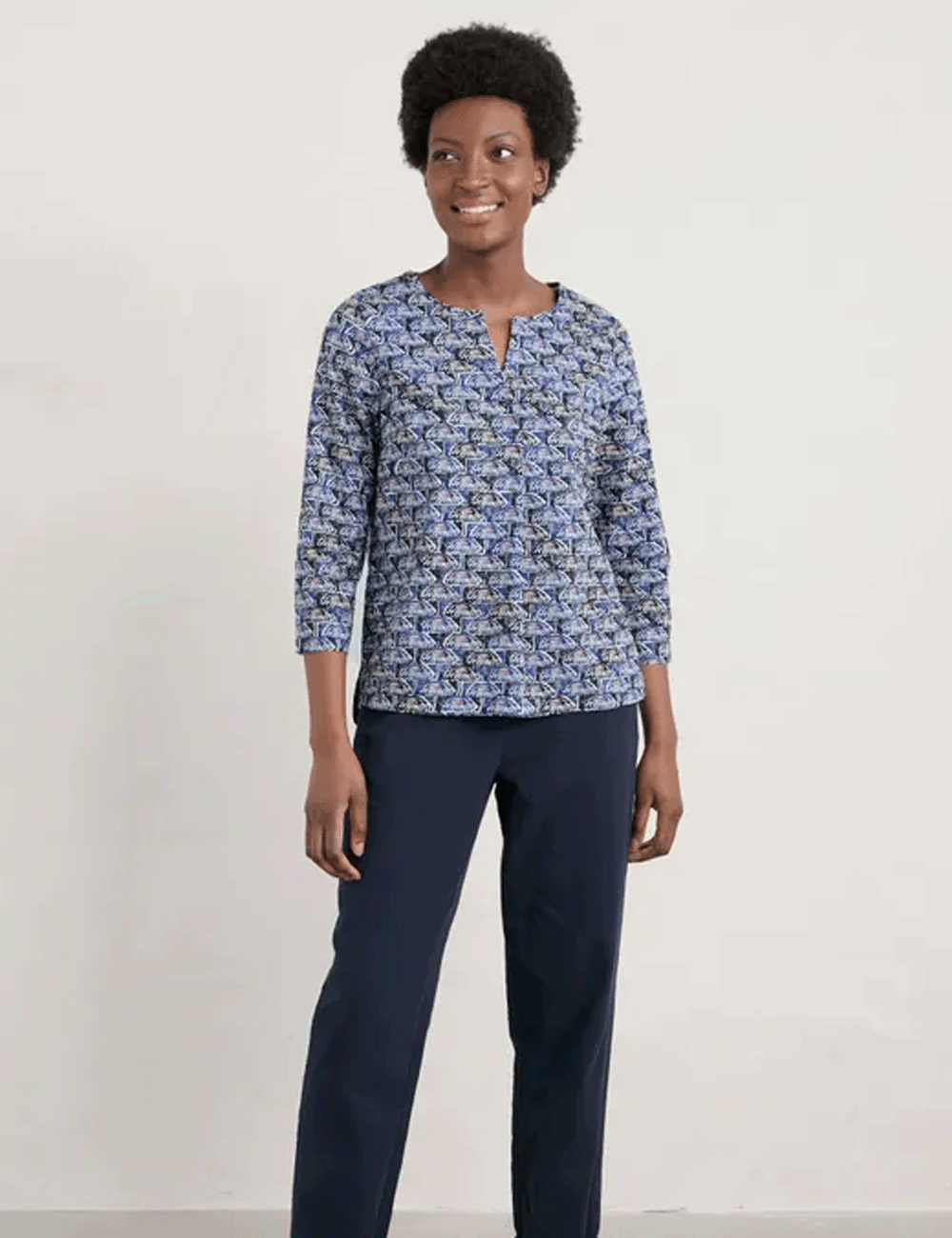 Woman wearing the Watercolour Sketch Top with navy trousers